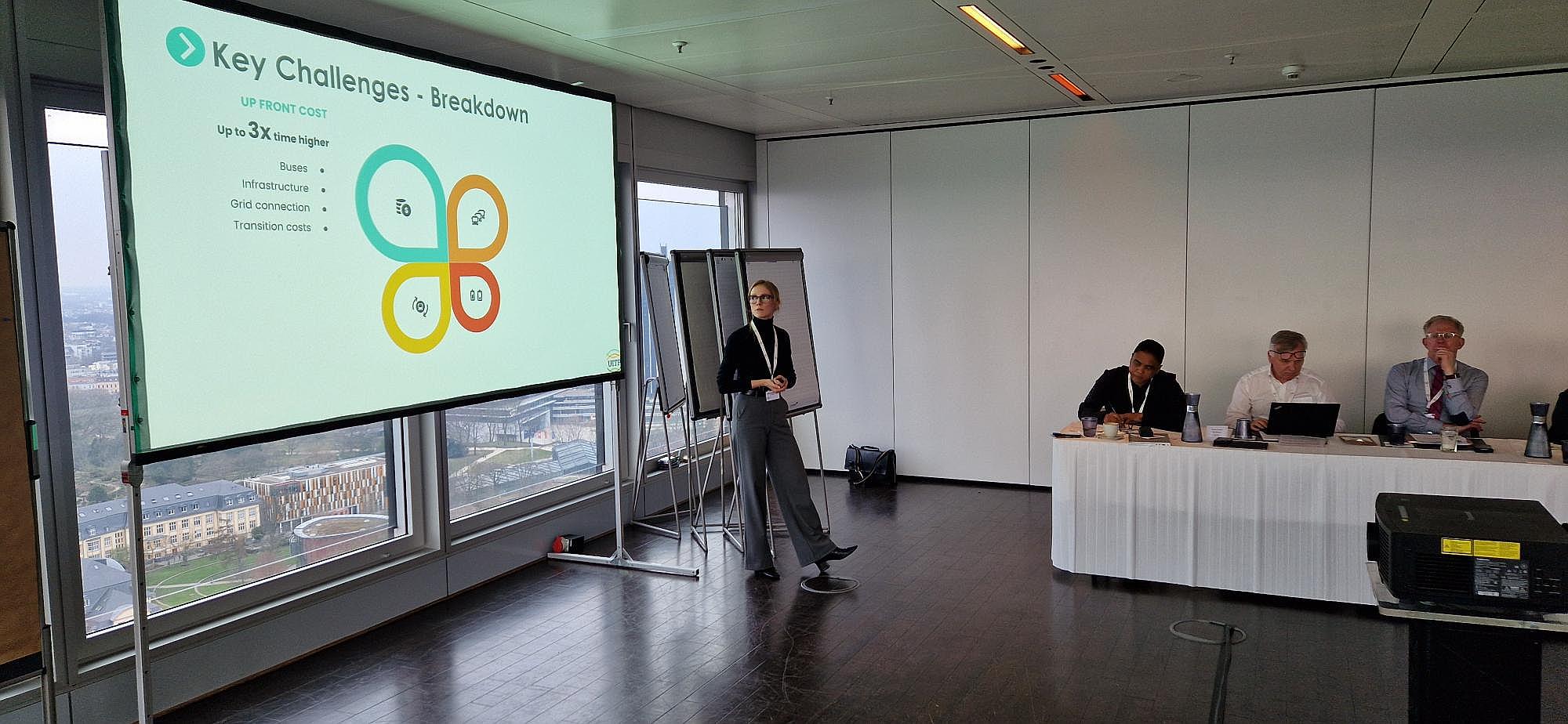 Catharina Michels lecturing at UITP in front of a slide titled ‘Key Challenges — Breakdown’